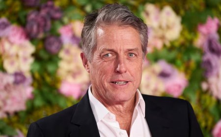 Hugh Grant looks to be one tired tennis fan at Wimbledon