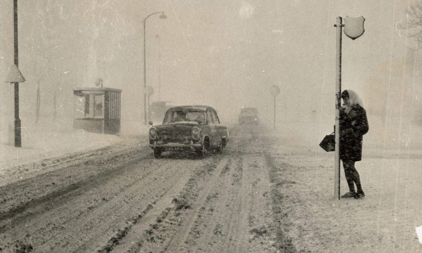 1969: One brave traveller waits for a bus on Provost Fraser Drive as cars slither through the whiteout conditions in 1969. Image: DC Thomson
