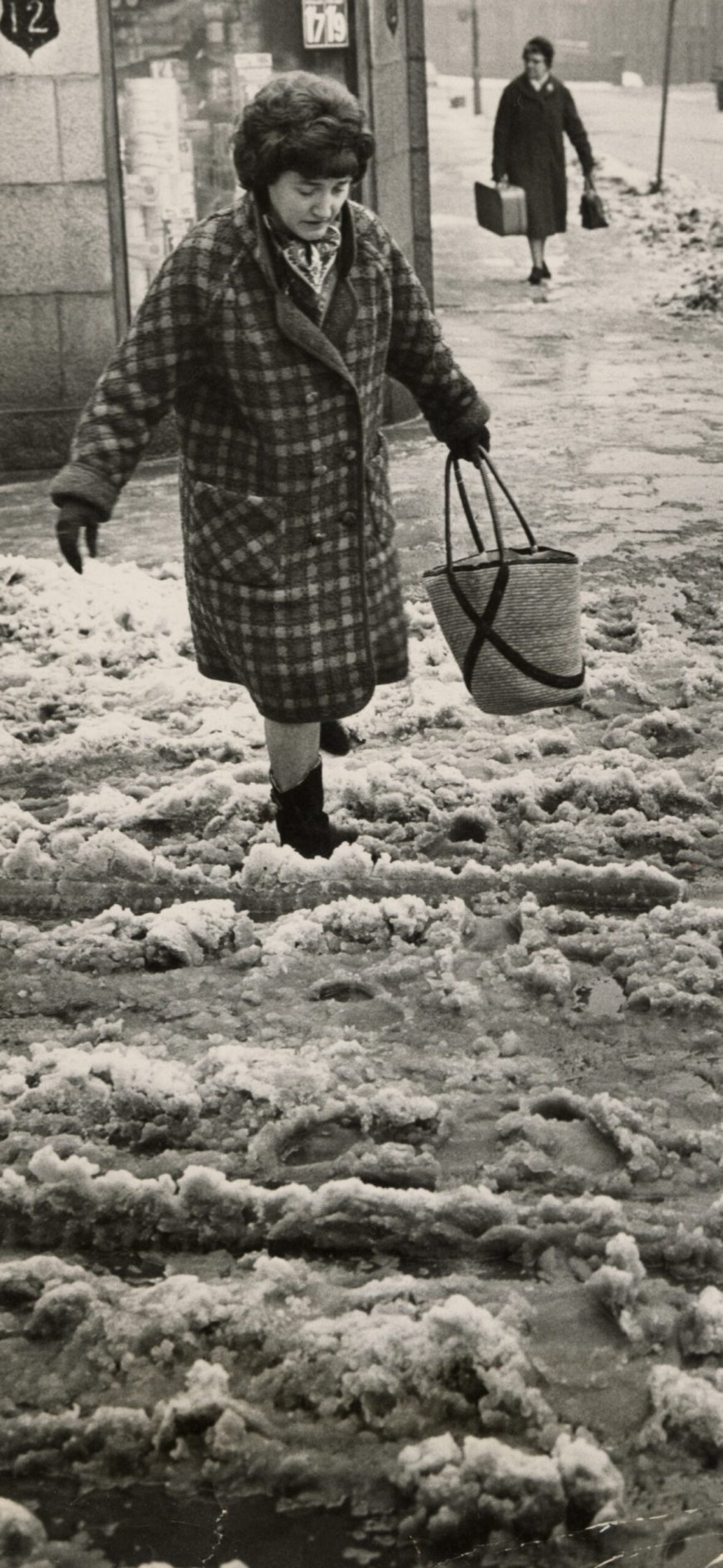 1969: One of the many Aberdonians who encountered a sea of slush in the city. This was the scene at the corner of Kintore Place and Rosemount Viaduct. Image: DC Thomson